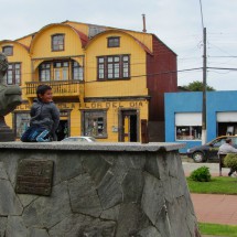 Boy with Bernardo O&#039;Higgins, the Chilean National Hero. Yellow front of a hardware and flower store of Maulin in the background.